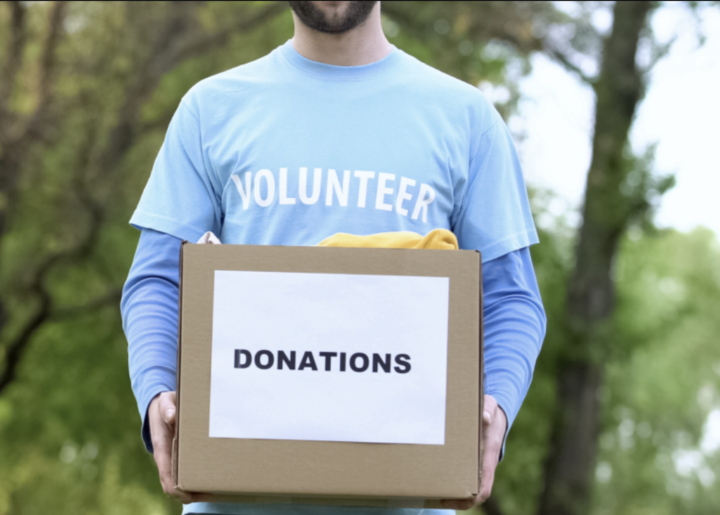 Volunteer holding donation box