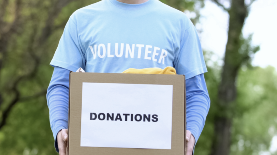 Volunteer holding donation box